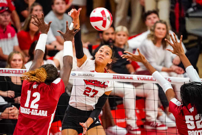 Oct 21, 2023; Lincoln, NE, USA; Nebraska Cornhuskers outside hitter Harper Murray (27) attacks against Wisconsin Badgers outside hitter Temi Thomas-Ailara (12) during the fourth set.